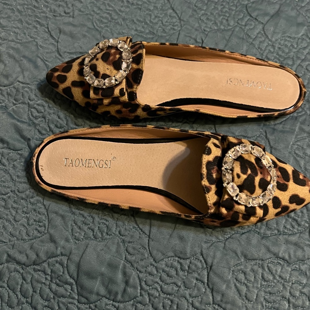 Animal print flats with decorative buckle.  Never worn.  Size 8